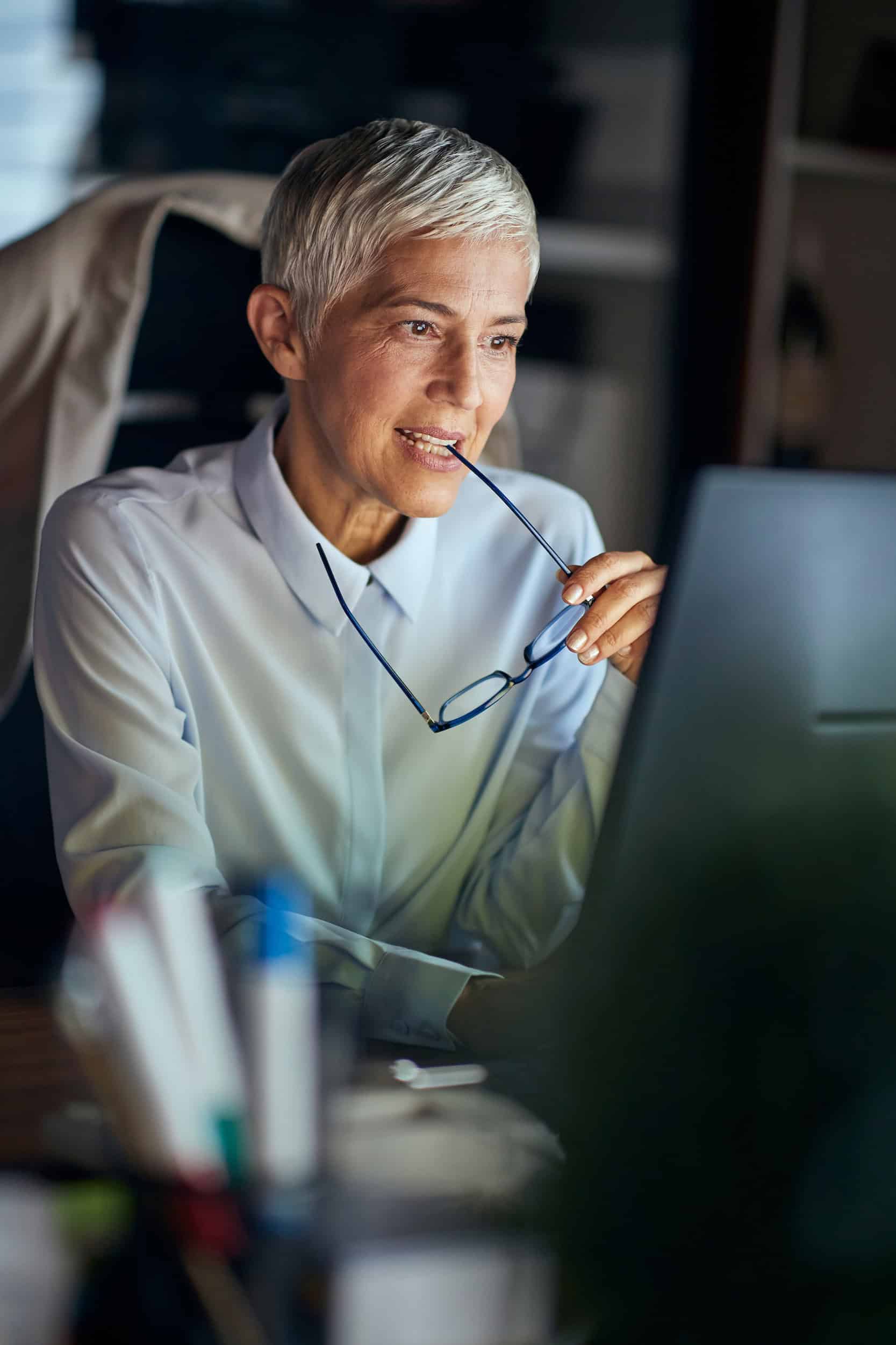 Senior executive woman working late