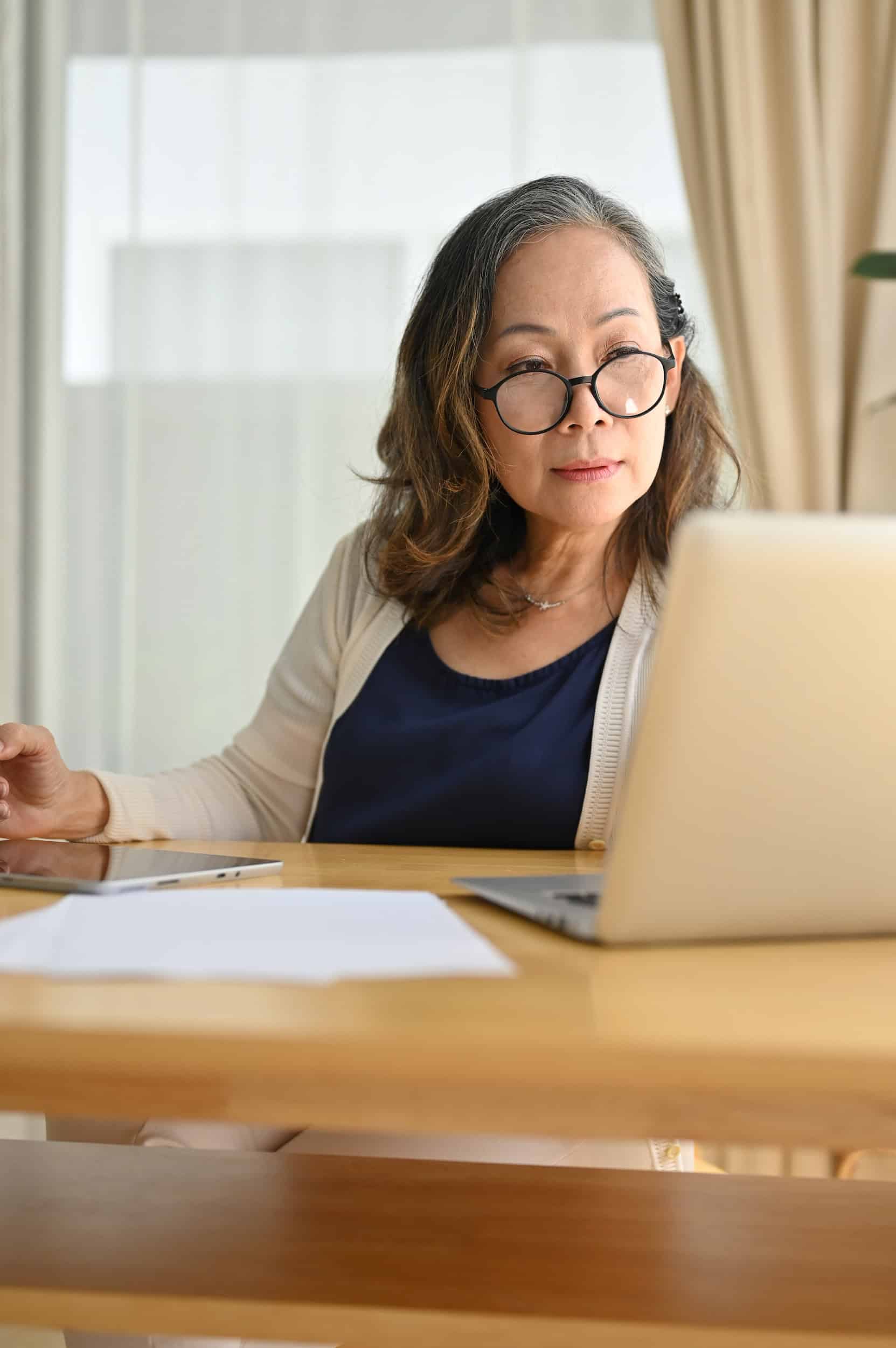 Senior female executive working at a laptop